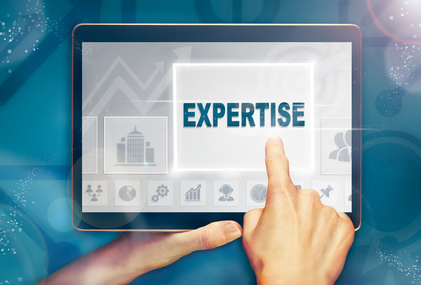 A hand selecting a Expertise business concept on a clear screen with a colorful blurred background.